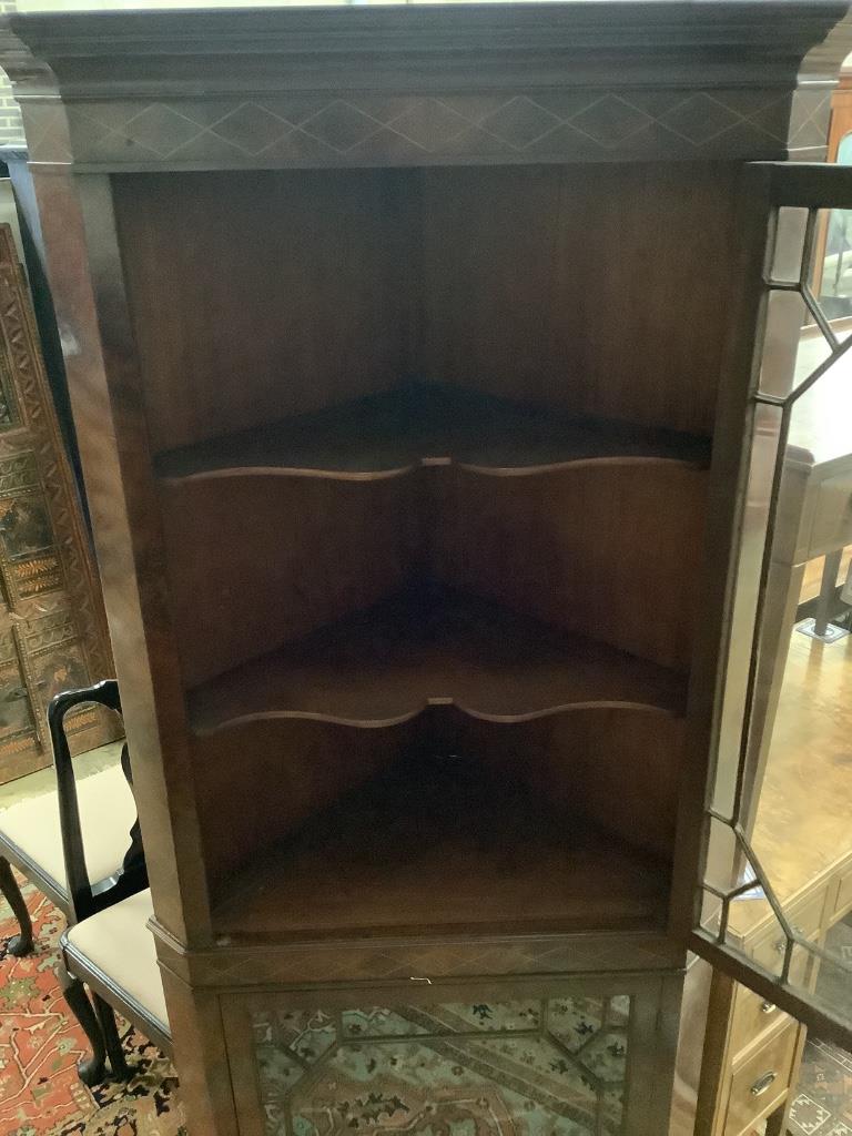 A reproduction mahogany standing corner cabinet, width 86cm depth 56cm height 205cm